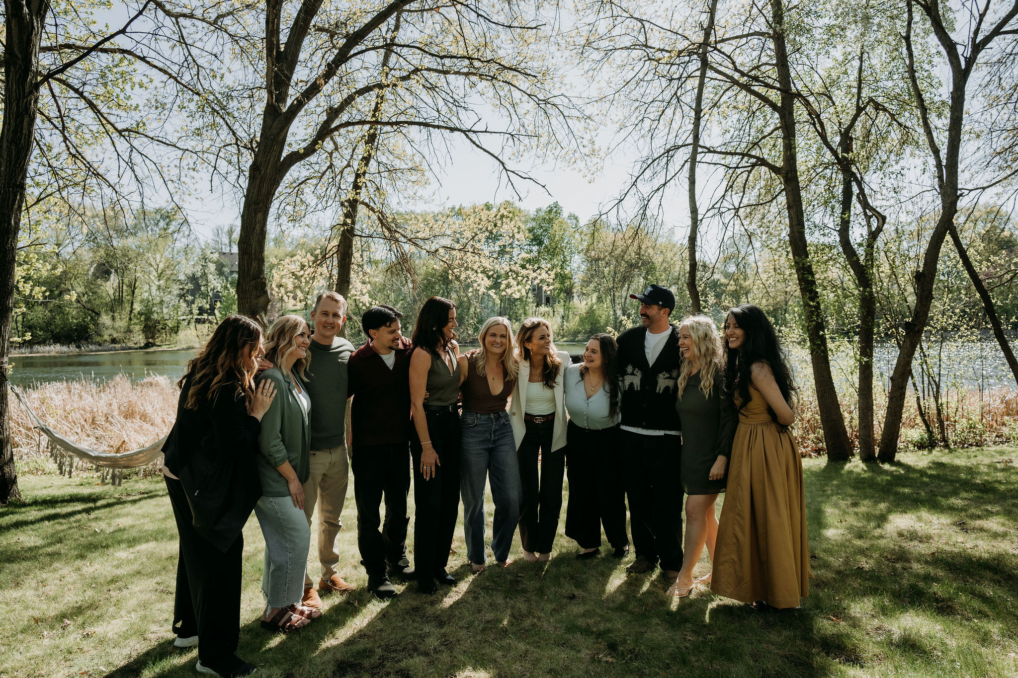 The team gathered together by the river, under the trees