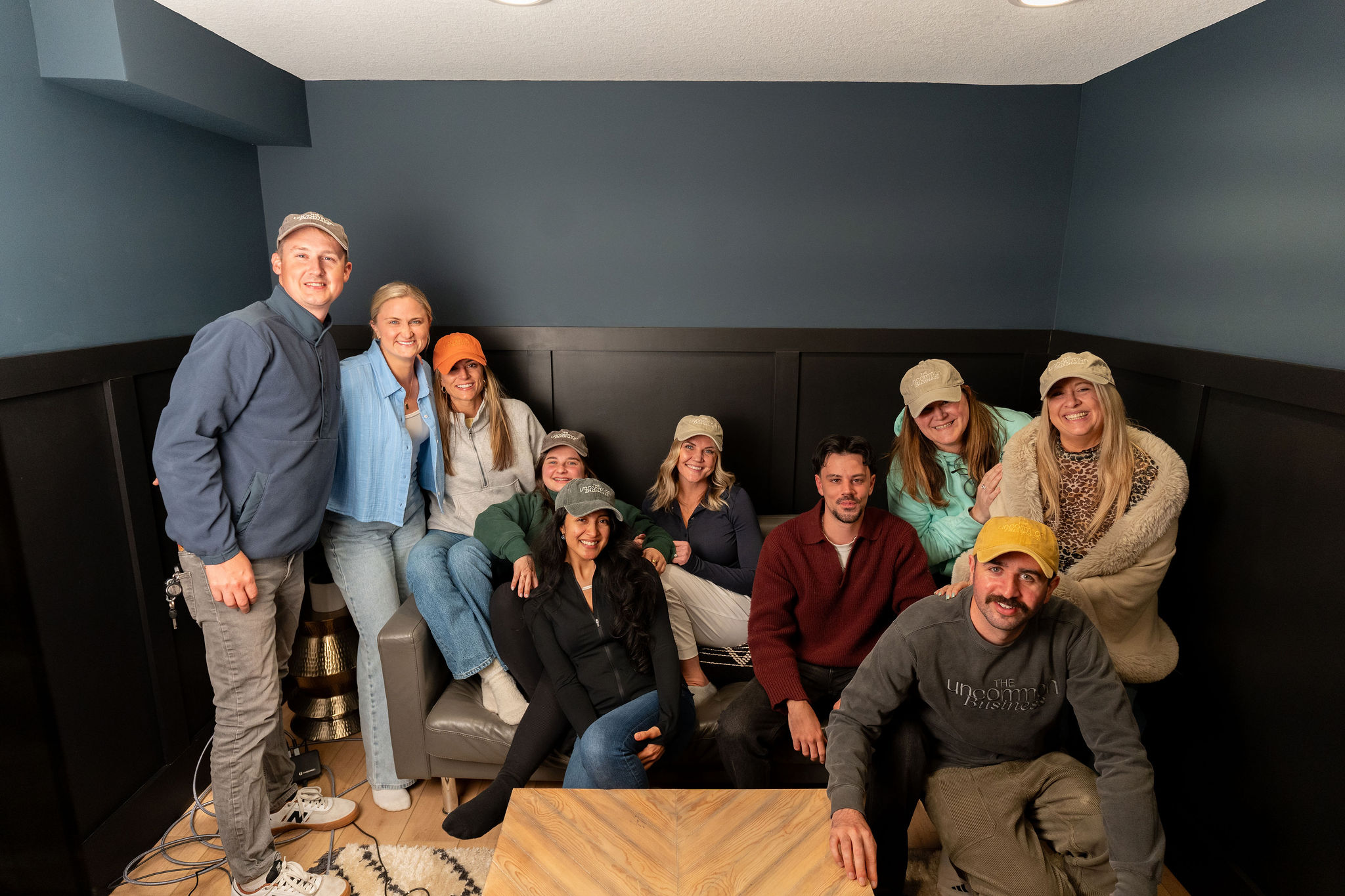 The team gathered together on a couch, leaning in